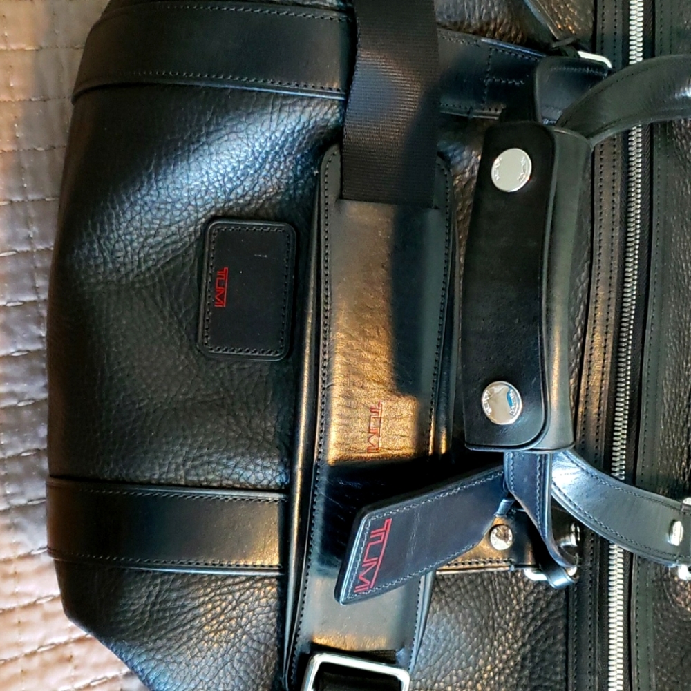 Tumi elegant black leather large  weekend duffel bag.